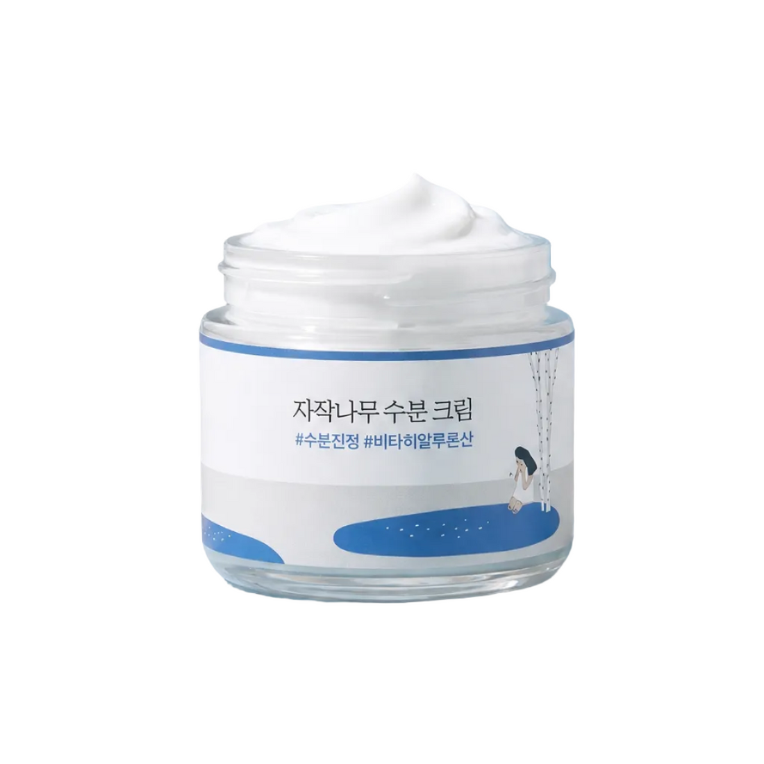 Skincare jar on a blue stone with branches and leaves in the background